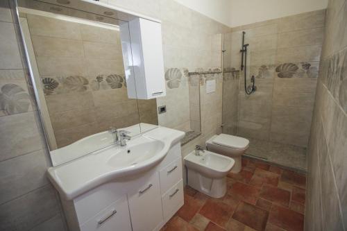 a bathroom with a sink and a toilet at Il Lentischio in Cala Sapone