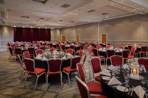 a large room with tables and chairs in a room at The Park Royal Hotel & Spa in Warrington