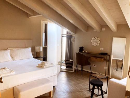 a bedroom with a bed and a desk in a room at Gatto Bianco Rooms 42 in Bergamo