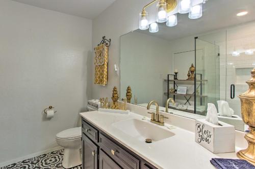 a bathroom with a sink and a toilet and a mirror at Grans Getaway - Peaceful Texas Retreat 