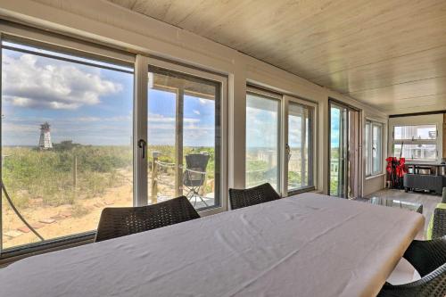 a large white table in a room with a large window at Charming Oceanfront Home on Salisbury Beach in Salisbury