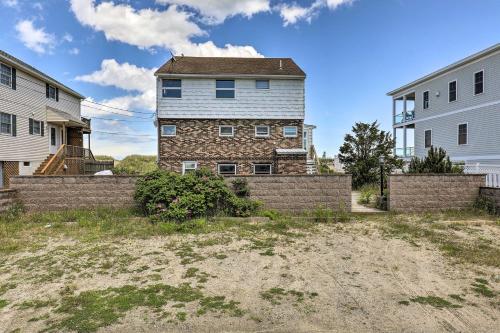 a house in the middle of two buildings at Charming Oceanfront Home on Salisbury Beach in Salisbury