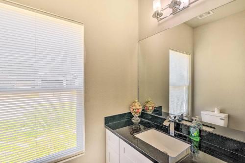 a bathroom with a sink and a large mirror at 7 Mi to Ocean Family-Friendly Texas City Home! in Texas City