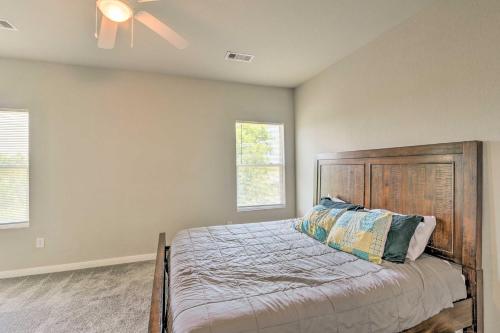 a bedroom with a bed with a ceiling fan at 7 Mi to Ocean Family-Friendly Texas City Home! in Texas City
