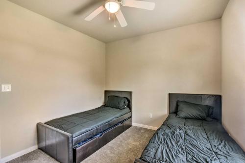 a bedroom with two beds and a ceiling fan at 7 Mi to Ocean Family-Friendly Texas City Home! in Texas City