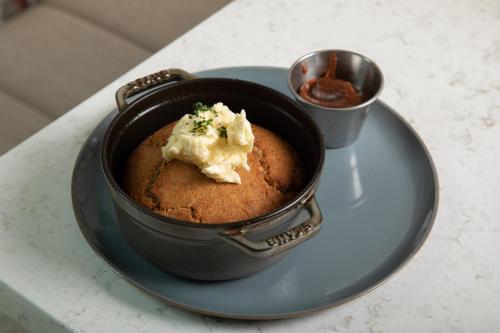 a bowl of food on a plate on a table at Virgin Hotels New Orleans in New Orleans