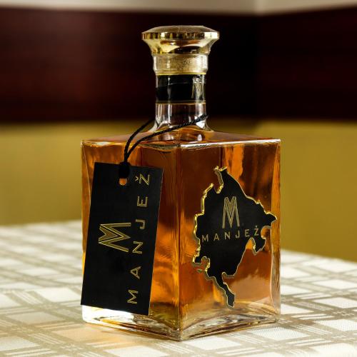 a bottle of molasses sitting on a table at Restoran & Motel Manjež in Bijelo Polje