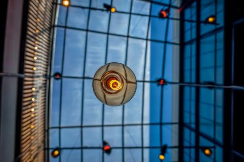 a ceiling with a light in the middle of a building at Backstage Hotel - an Atlas Boutique Hotel in Tel Aviv