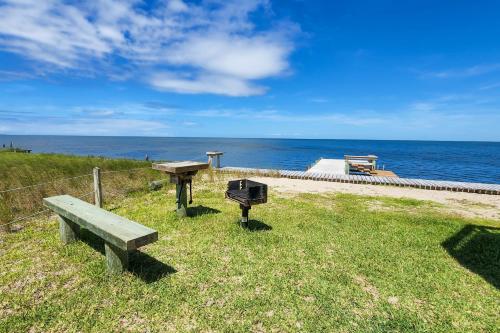 a picnic table and a grill next to the ocean at Lapha Amanzi #6-PA in Avon
