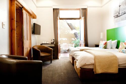 Ένα ή περισσότερα κρεβάτια σε δωμάτιο στο Ashanti Gardens Guesthouse