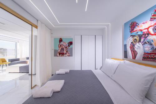 a bedroom with a large bed and a living room at H Experience Spectacular Rooftop Loft in Heraklio