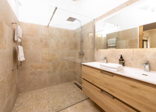 a bathroom with a shower and a sink and a mirror at Côté vignes cassis in Cassis