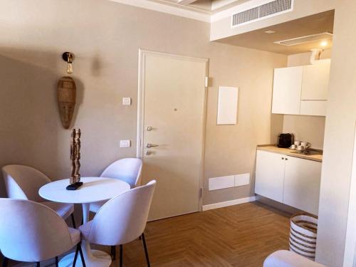 a room with a table and chairs and a kitchen at Gatto Bianco Bergamo Apartment in Bergamo
