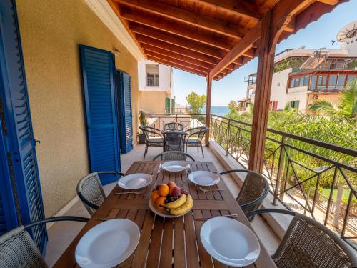 a table with a bowl of fruit on a balcony at The Salnik Beach Apartment in Limassol