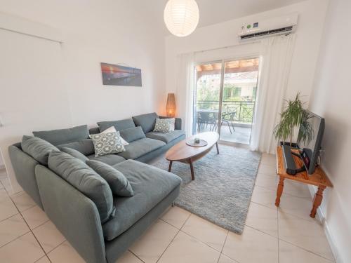 a living room with a couch and a table at The Salnik Beach Apartment in Limassol