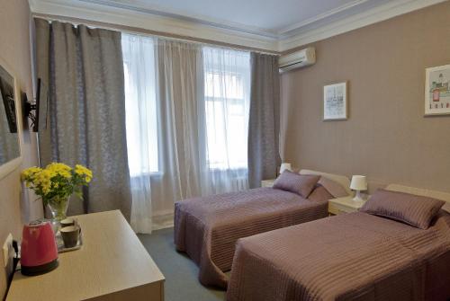 
Кровать или кровати в номере Отель Мэрри Поппинс
