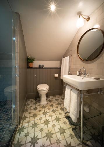 a bathroom with a sink and a toilet at Eleven Didsbury Park Hotel in Manchester