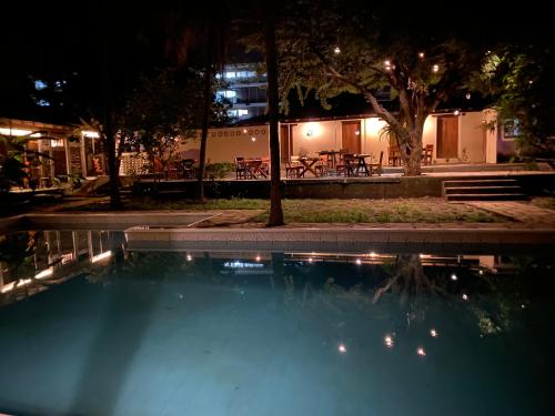 a swimming pool at night with a table at Hostal Casa Abierta in León