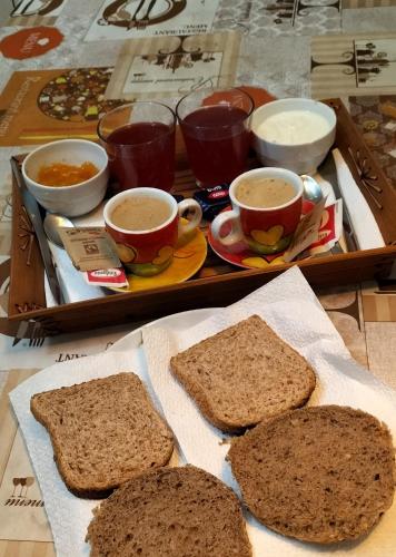 a tray with two slices of bread and two cups of coffee at Antico Borgo di Torri in Sovicille
