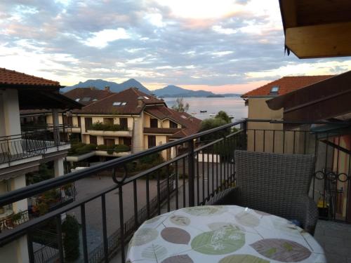 a balcony with a table and a view of the water at Dreaming Feriolo - mansarded apartment by Danilo Apartments in Baveno