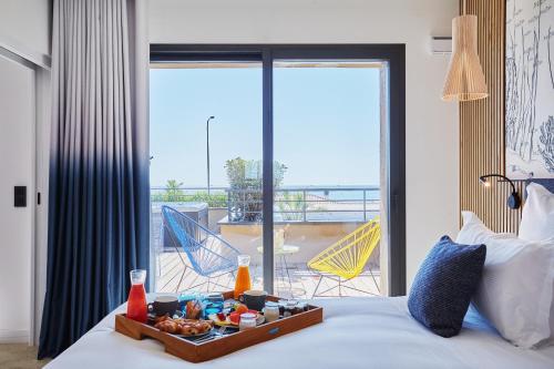 Katil atau katil-katil dalam bilik di EDEN HÔTEL