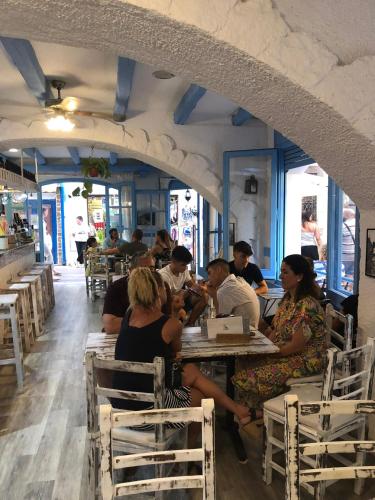 a group of people sitting at tables in a restaurant at Hotel Bergantí in Tossa de Mar
