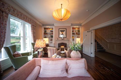 a living room with a couch and a fireplace at Eleven Didsbury Park Hotel in Manchester