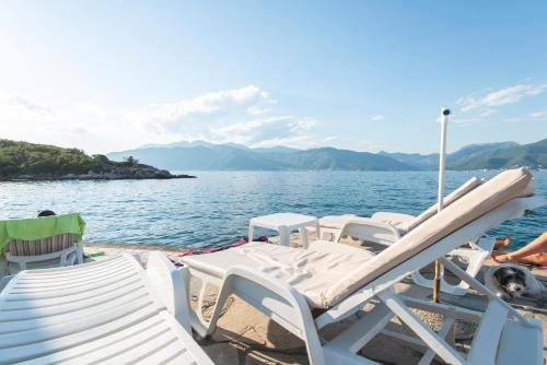 a group of chairs on a boat in the water at Casa del Mare Bjelila in Tivat