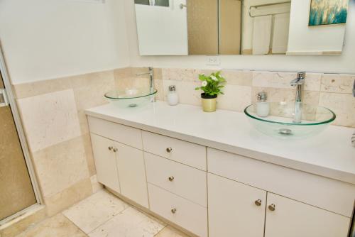 a bathroom with two sinks and a shower at Rio Suites in Tijuana