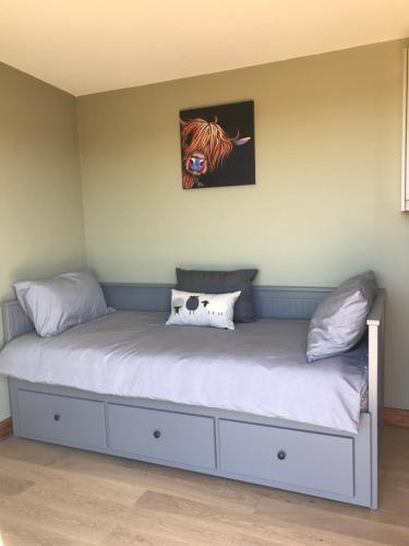 a bed with two pillows on it in a room at Ben Klibreck, Ben Hope, Ben Hee in Torroboll