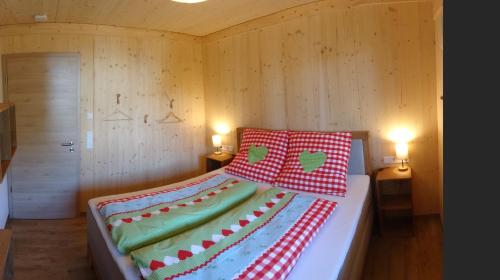 a bed with two pillows on it in a room at WaldBlick im Happy Allgäu - Wohnung mit großer Dachterrasse in Leutkirch im Allgäu