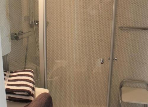 a shower with a glass door in a bathroom at Iderhoff Iderhoff 08 in Norderney