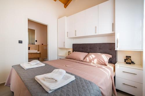 a bedroom with a bed with two towels on it at HACIENDA GASPAROVIC in Sukošan