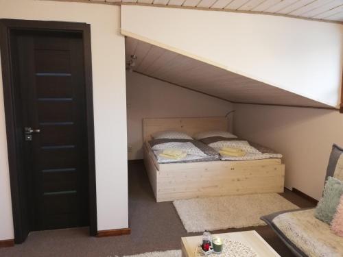 a bunk bed in a room with a bunk bed under a loft bed at Penzión u Coľa in Prievidza