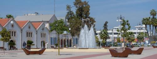 a fountain in a courtyard in front of a building at HAVEN HOUSE in Larnaca