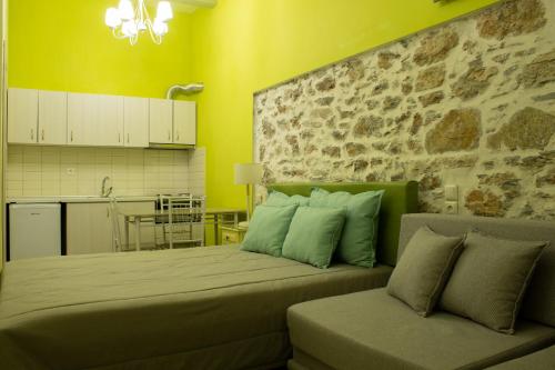 a bedroom with a large bed and a kitchen at AFISSOS SEASIDE STUDIOS in Afissos