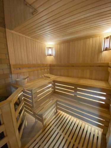 an empty wooden sauna with wooden benches in it at MirOtel Hotel in Astana