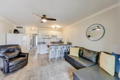 a living room with a couch and a kitchen at Sea Cabin 121-B in Isle of Palms