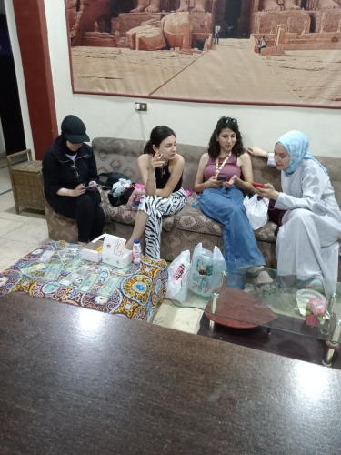 a group of people sitting on a couch at New One Hotel in Cairo