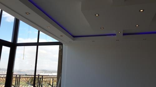 a room with windows and a ceiling with blue ceilings at Eagle Nest Luxury Accommodation in Roodepoort