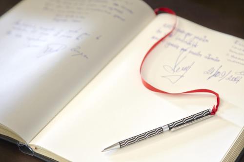 a pen sitting on top of an open book at Hotel Rural Gaintza in Getaria