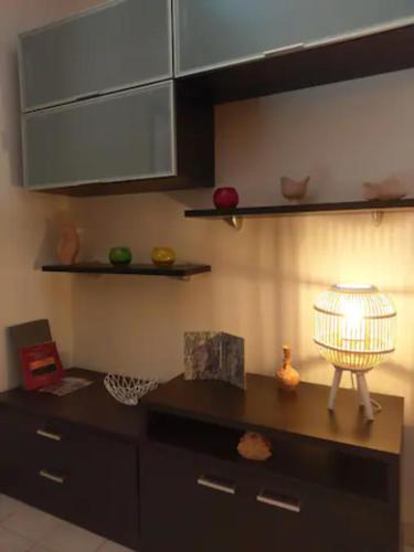 a kitchen with a table with a lamp on it at La casa blu superior in Lipari