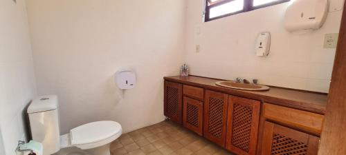 a bathroom with a toilet and a sink at Hostel Praia 102 in Ubatuba