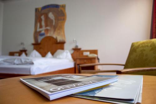 a book sitting on top of a table in a hotel room at Das Bergland - Vital & Activity in San Leonardo in Passiria