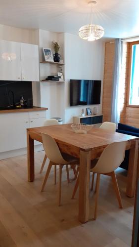 - une table à manger et des chaises dans la cuisine dans l'établissement T3 moderne et cosy avec linge et ménage compris, à Cauterets
