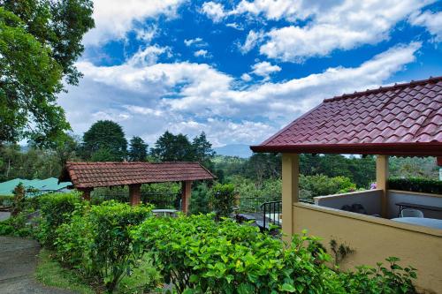 a house with two gazebos in a garden at Hotel Villa Zurqui in San José