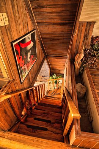 a spiral staircase in a wooden house with a picture at Hotel Villa Zurqui in San José