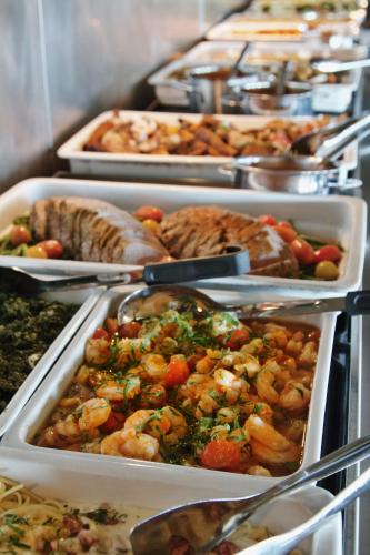 a buffet with many trays of food on display at Oset Fjellhotell in Gol