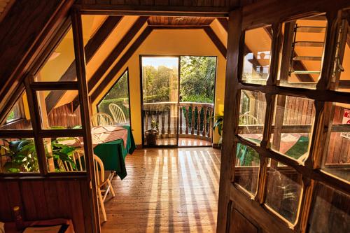 a view from the inside of a house with a wooden door at Hotel Villa Zurqui in San José