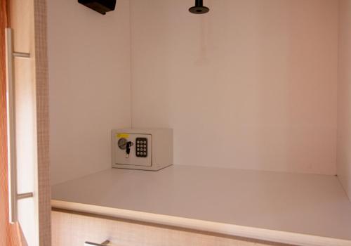 a kitchen with a clock on a white wall at Seaside, relaxing family house with playground! Villa Lavrys 4 in Marathi